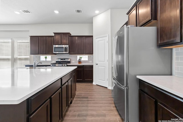 kitchen featuring visible vents, appliances with stainless steel finishes, and backsplash