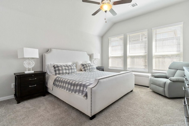 bedroom with light colored carpet, visible vents, vaulted ceiling, and ceiling fan