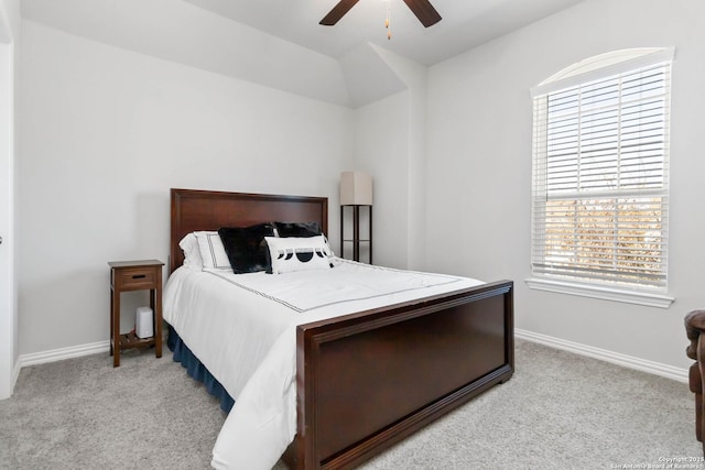 bedroom with baseboards, a ceiling fan, and light colored carpet