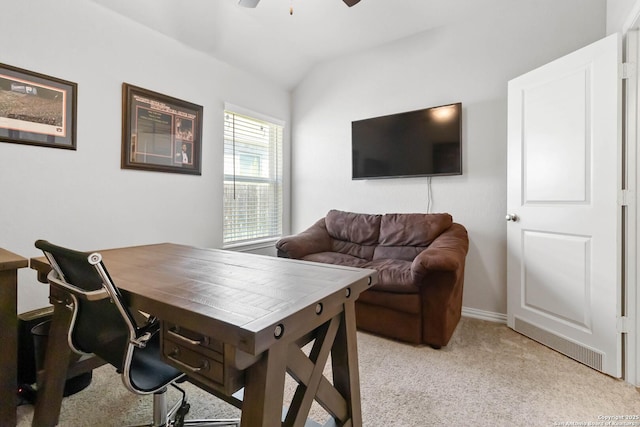 home office with lofted ceiling, ceiling fan, and light colored carpet