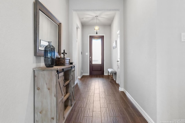 entrance foyer featuring baseboards and wood tiled floor