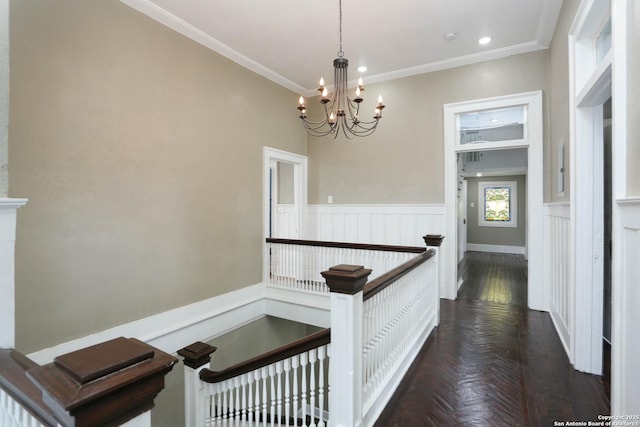 hallway featuring recessed lighting, a wainscoted wall, a notable chandelier, an upstairs landing, and crown molding