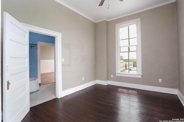 unfurnished room featuring a ceiling fan, crown molding, baseboards, and dark wood-type flooring