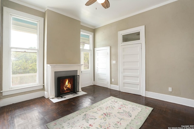 unfurnished living room featuring a ceiling fan, a fireplace with flush hearth, a wealth of natural light, and baseboards