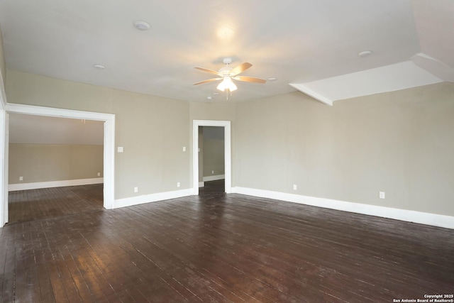 spare room with dark wood-type flooring, baseboards, and a ceiling fan