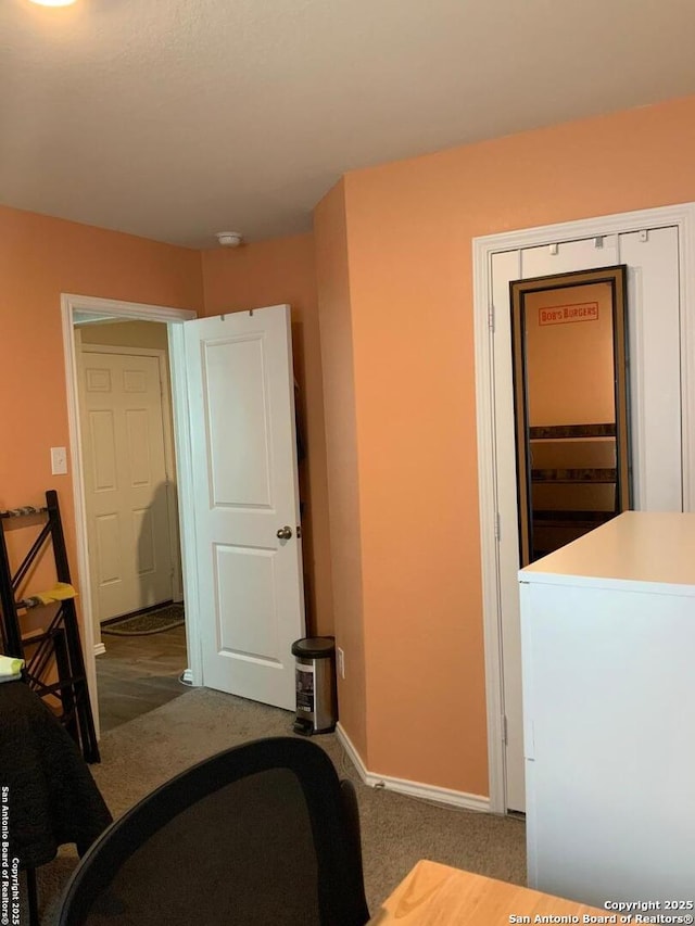 carpeted bedroom featuring baseboards