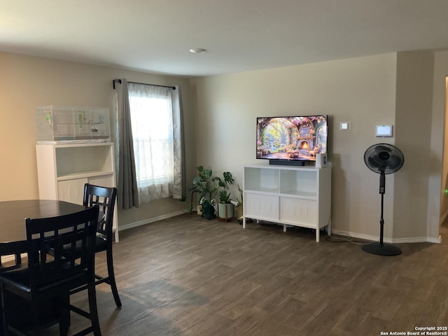 dining space with dark wood finished floors and baseboards