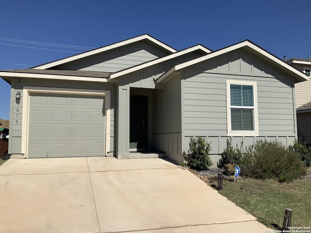 single story home with a garage, board and batten siding, and concrete driveway