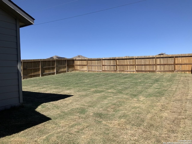 view of yard with a fenced backyard