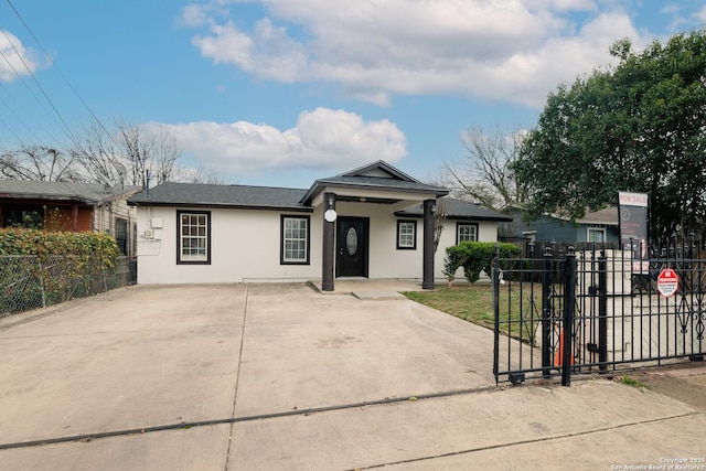 view of front of house with fence and stucco siding