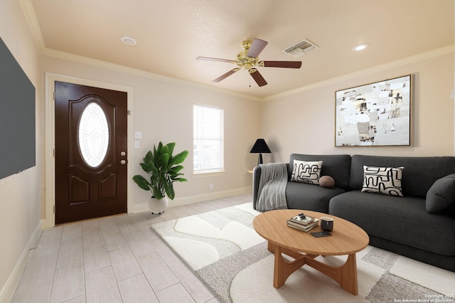 entrance foyer featuring visible vents, ornamental molding, and light wood-style flooring