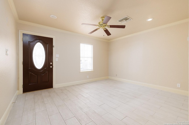 entryway with ornamental molding and baseboards