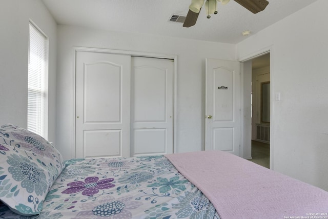 bedroom featuring visible vents, a closet, and a ceiling fan