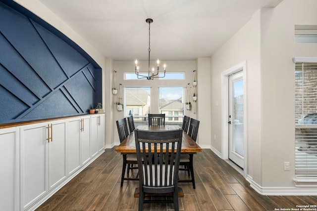 dining room featuring baseboards, dark wood finished floors, and an inviting chandelier