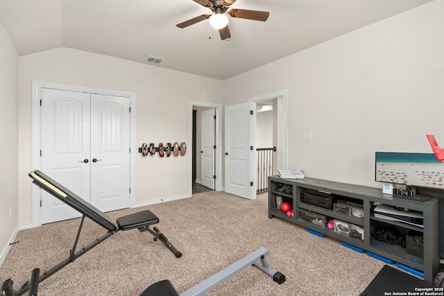 exercise room with baseboards, visible vents, a ceiling fan, vaulted ceiling, and carpet flooring