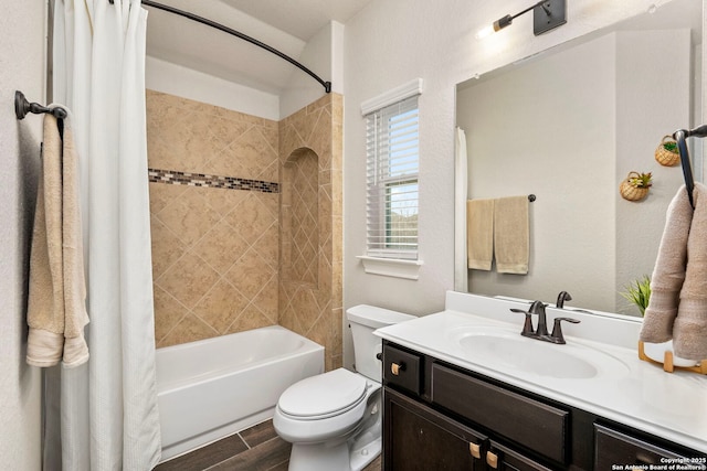 full bathroom featuring wood finish floors, vanity, toilet, and shower / bath combo with shower curtain