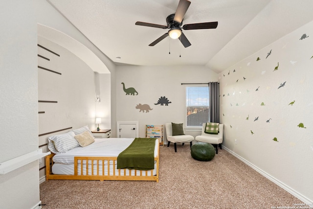 carpeted bedroom with lofted ceiling, ceiling fan, and baseboards