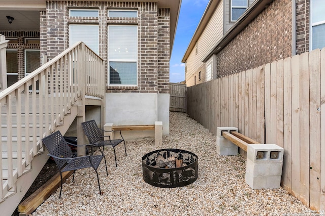 view of patio / terrace featuring an outdoor fire pit and a fenced backyard