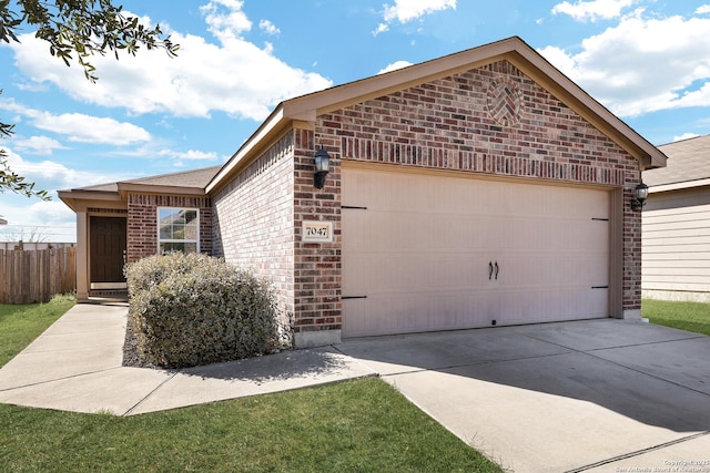 view of home's exterior featuring an attached garage, fence, concrete driveway, and brick siding