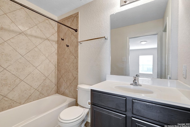 full bathroom with toilet, vanity, shower / bathing tub combination, and a textured wall