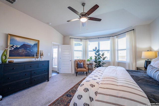 carpeted bedroom with lofted ceiling, ceiling fan, and visible vents