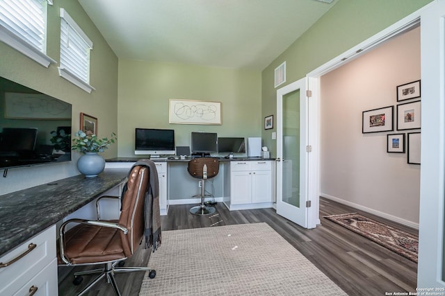 home office featuring baseboards, visible vents, built in study area, dark wood-style floors, and french doors