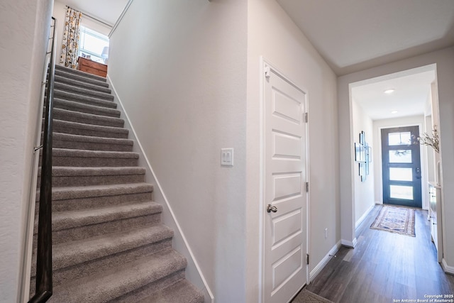 stairs with baseboards and wood finished floors