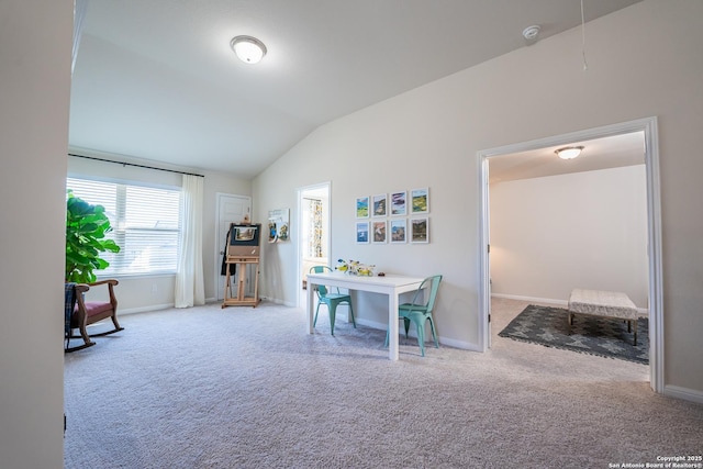 interior space featuring carpet, baseboards, and vaulted ceiling