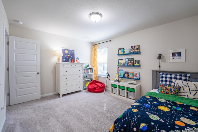 carpeted bedroom featuring baseboards