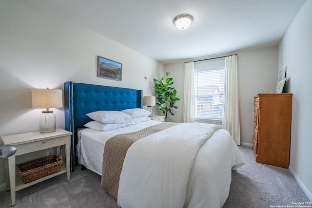 bedroom with carpet floors and baseboards