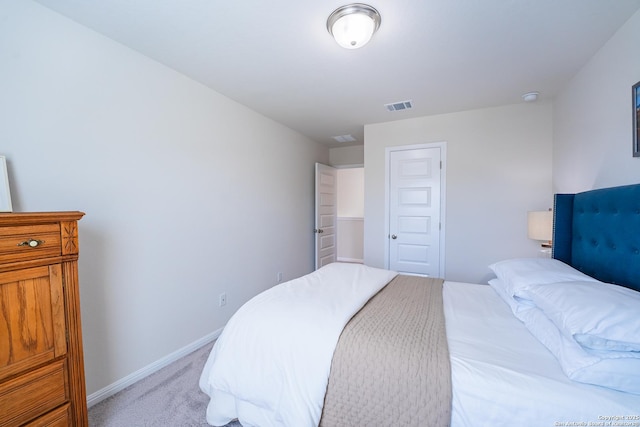 bedroom with light carpet, a closet, visible vents, and baseboards