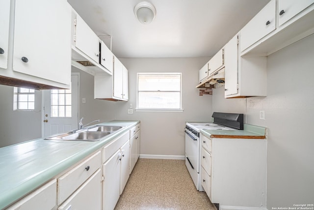 kitchen with under cabinet range hood, white electric range, a sink, baseboards, and light floors