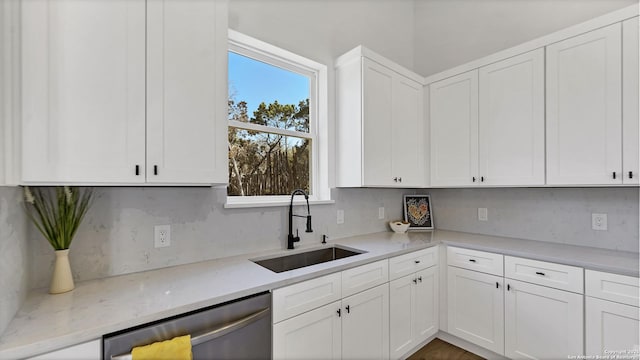 kitchen featuring white cabinetry, a sink, and dishwasher