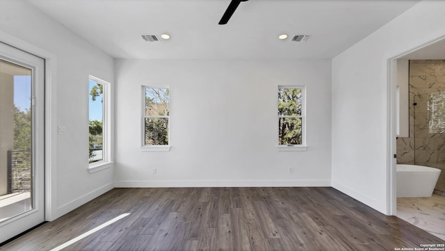 spare room with baseboards, visible vents, and recessed lighting