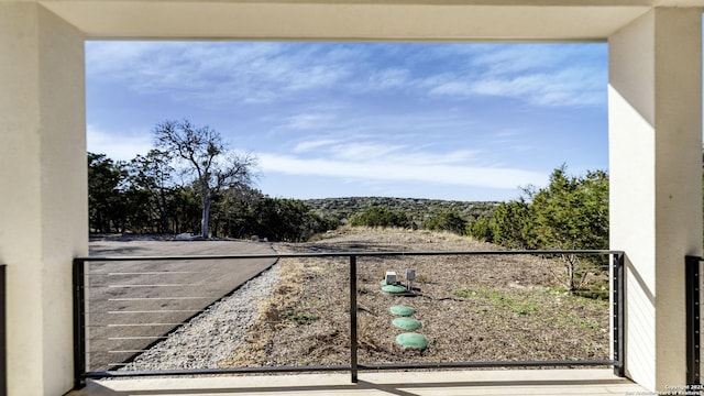 view of yard with a balcony