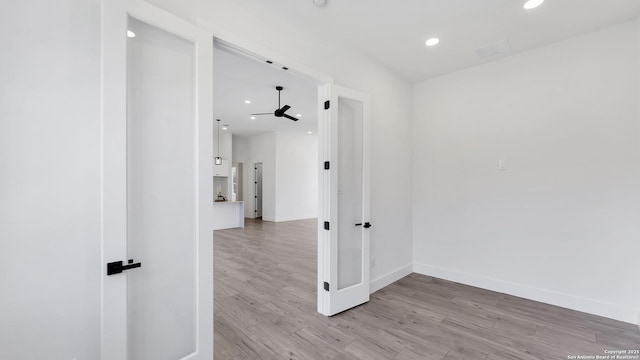 spare room with light wood-type flooring, visible vents, baseboards, and recessed lighting