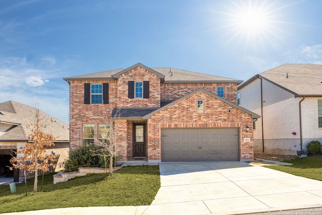 traditional-style house featuring an attached garage, brick siding, and a front yard