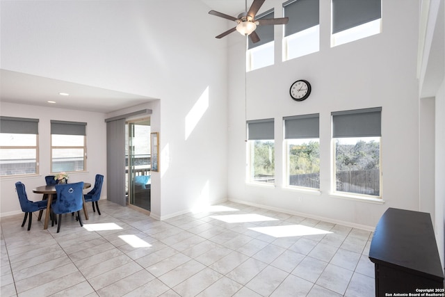 12816 Perdido, San Antonio, TX 78253 - living area featuring light tile patterned floors, a towering ceiling, a ceiling fan, and baseboards