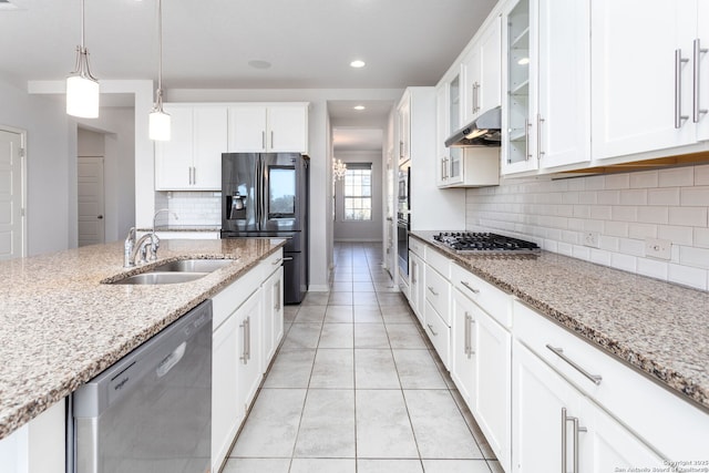 12816 Perdido, San Antonio, TX 78253 - kitchen with appliances with stainless steel finishes, glass insert cabinets, a sink, light stone countertops, and under cabinet range hood