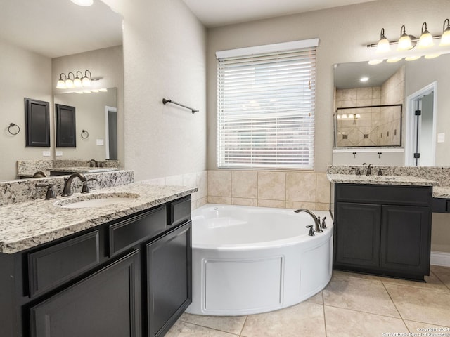 full bathroom with a tile shower, a sink, and tile patterned floors