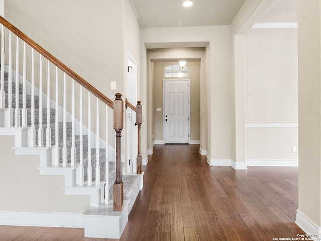 entryway featuring stairs, recessed lighting, baseboards, and wood finished floors