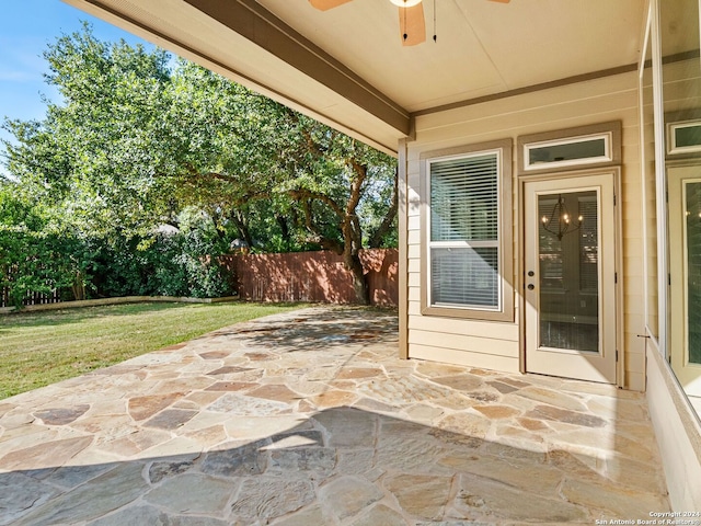 view of patio / terrace featuring ceiling fan and fence