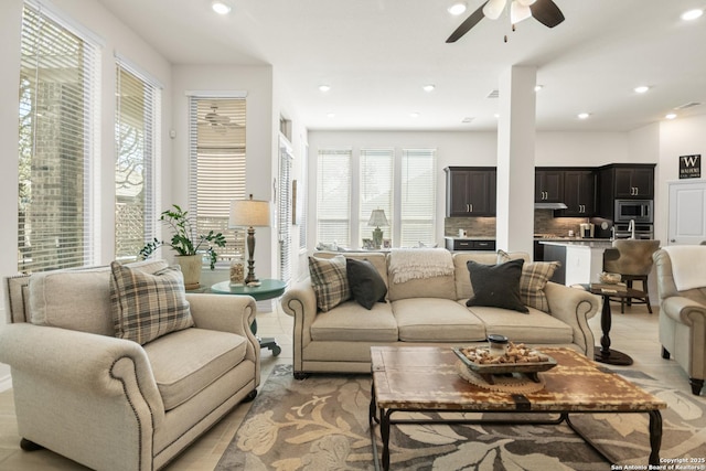 living room with a ceiling fan, recessed lighting, and a healthy amount of sunlight