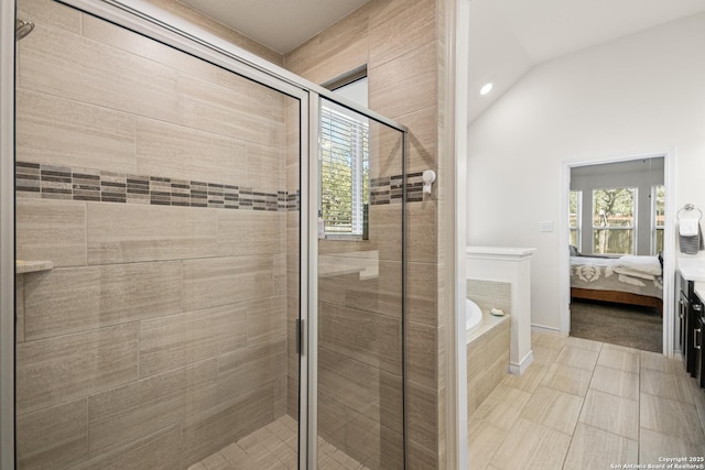 ensuite bathroom with lofted ceiling, a stall shower, connected bathroom, and a bath