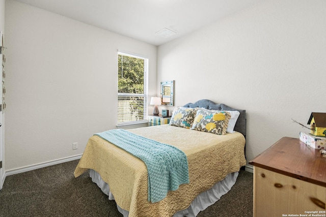 bedroom featuring visible vents, baseboards, and dark colored carpet