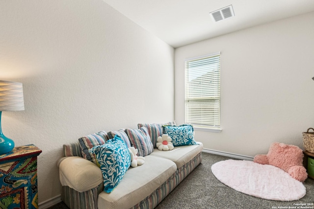 carpeted living area with baseboards and visible vents