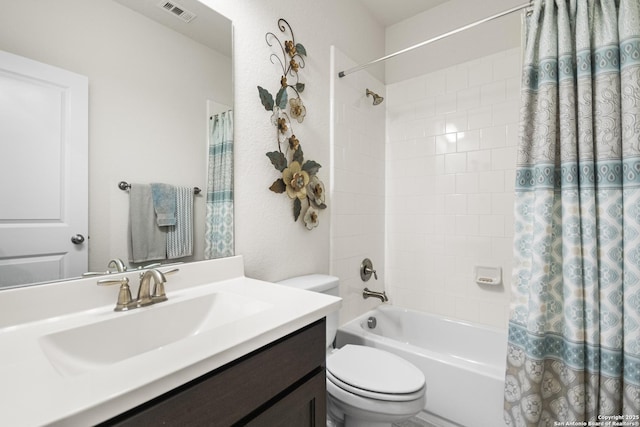 bathroom featuring toilet, shower / tub combo, vanity, and visible vents