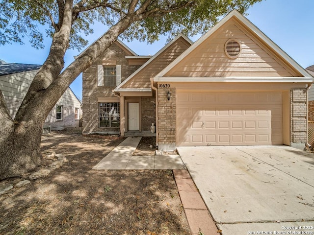 traditional home with brick siding, driveway, and an attached garage