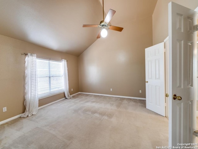 spare room featuring baseboards, high vaulted ceiling, a ceiling fan, and light colored carpet