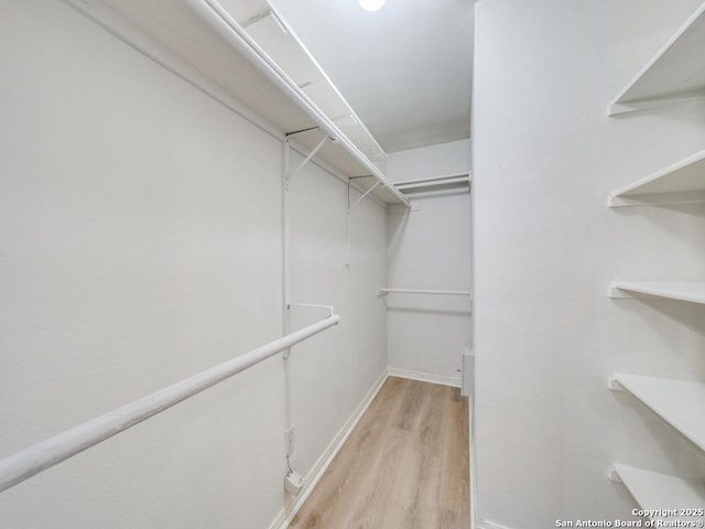 spacious closet with light wood-style floors